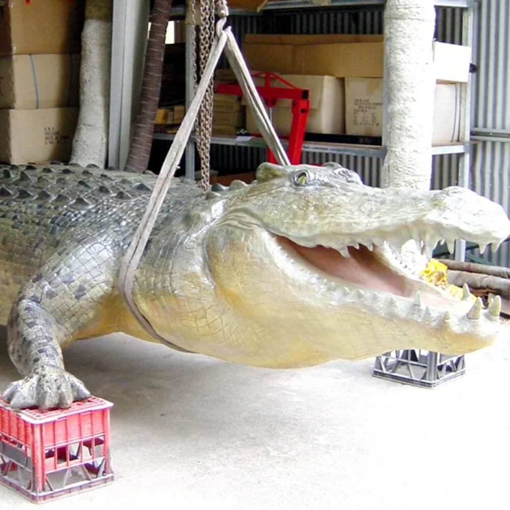 Giant Saltwater Crocodile sculpture elevated in workshop - painting in progress