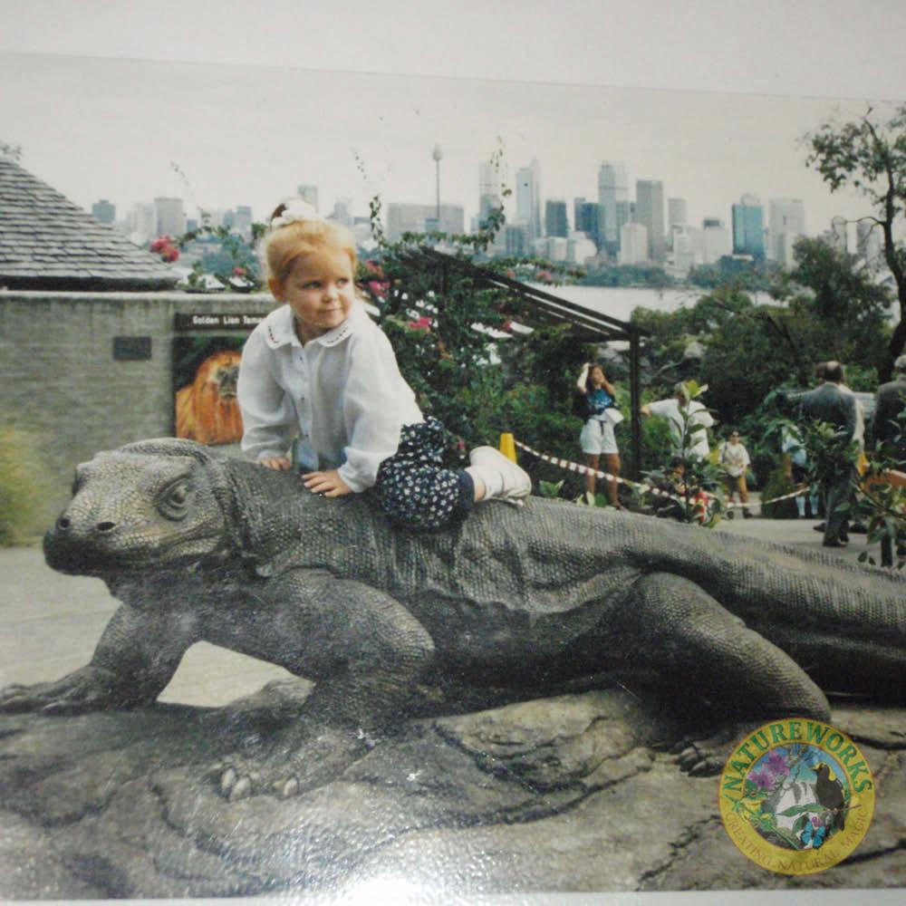 Natureworks Australia Komodo Dragon sculpture - front view- 080121 - shown with lttle girl sitting on top - at Taronga Zoo