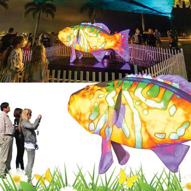 Natureworks Australia Coral Trout - White - Giant for public art displays and events - 120045White - showin with colour laser light shining on display - in Cairns Queensland - shown in display with people taking photos
