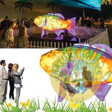 Natureworks Australia Coral Trout - White - Giant for public art displays and events - 120045White - showin with colour laser light shining on display - in Cairns Queensland - shown in display with people taking photos