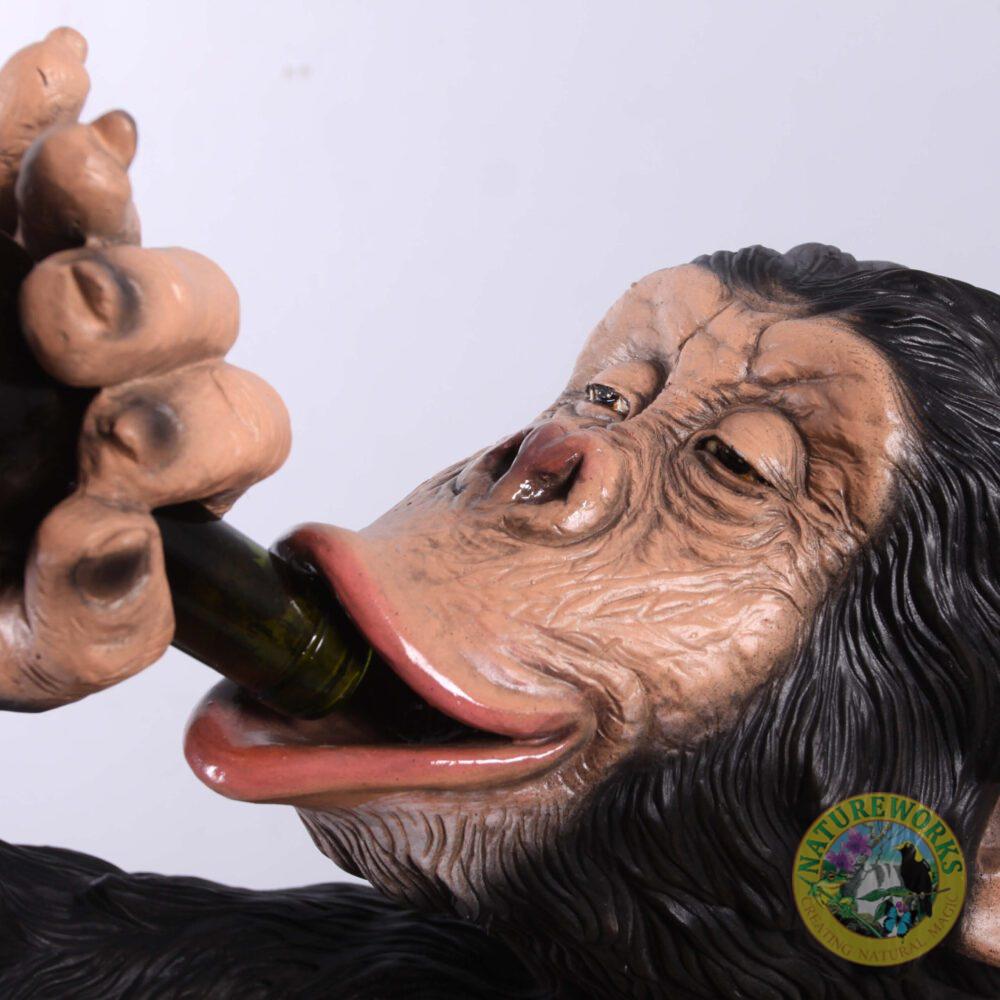 Natureworks Australia Chimpanzee sitting - statue-bozzy bottle holder - 140099 - close up of bottle in mouth