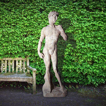 David Satue on Base - 030322RS - Roman stone finish - garden statue - front view shwon in garden