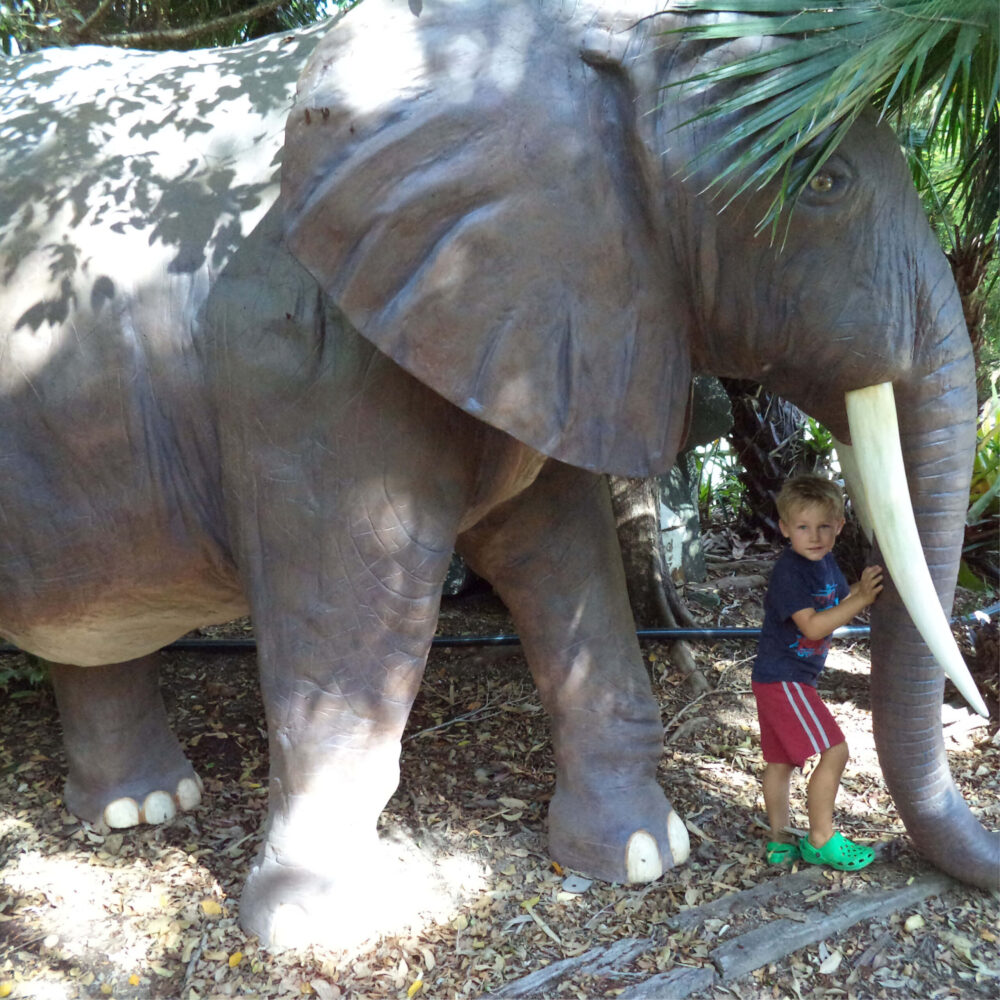 African Elephant - 8ft - 100059- L 374 x W 196 c 243cm - 230kg - standing pose - amazing sculpture - shown outside with little boy standing underneath
