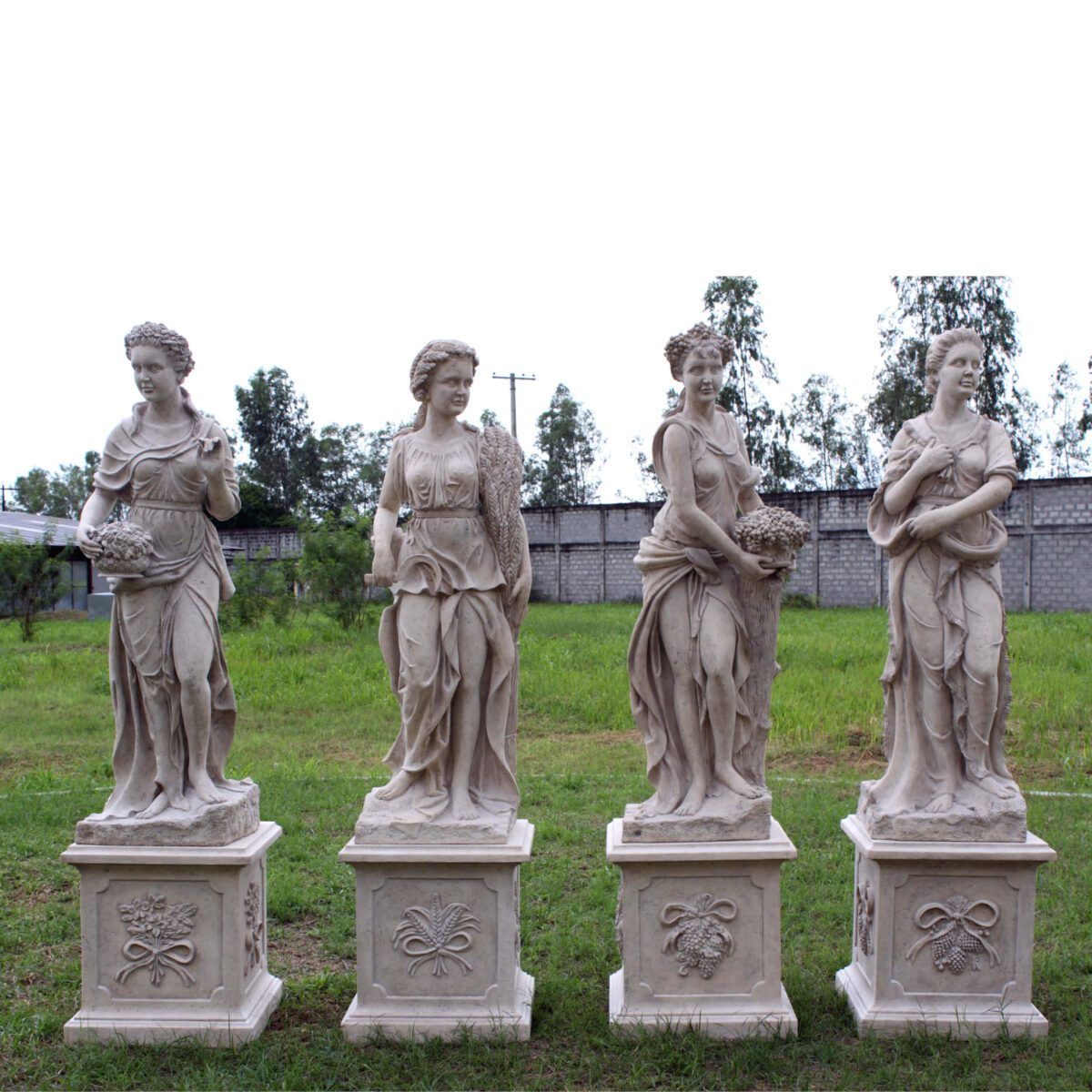 Natureworks Australia Four season Statue set of 4- including Winter -Roman stone finish - 090060RS - shown outside.