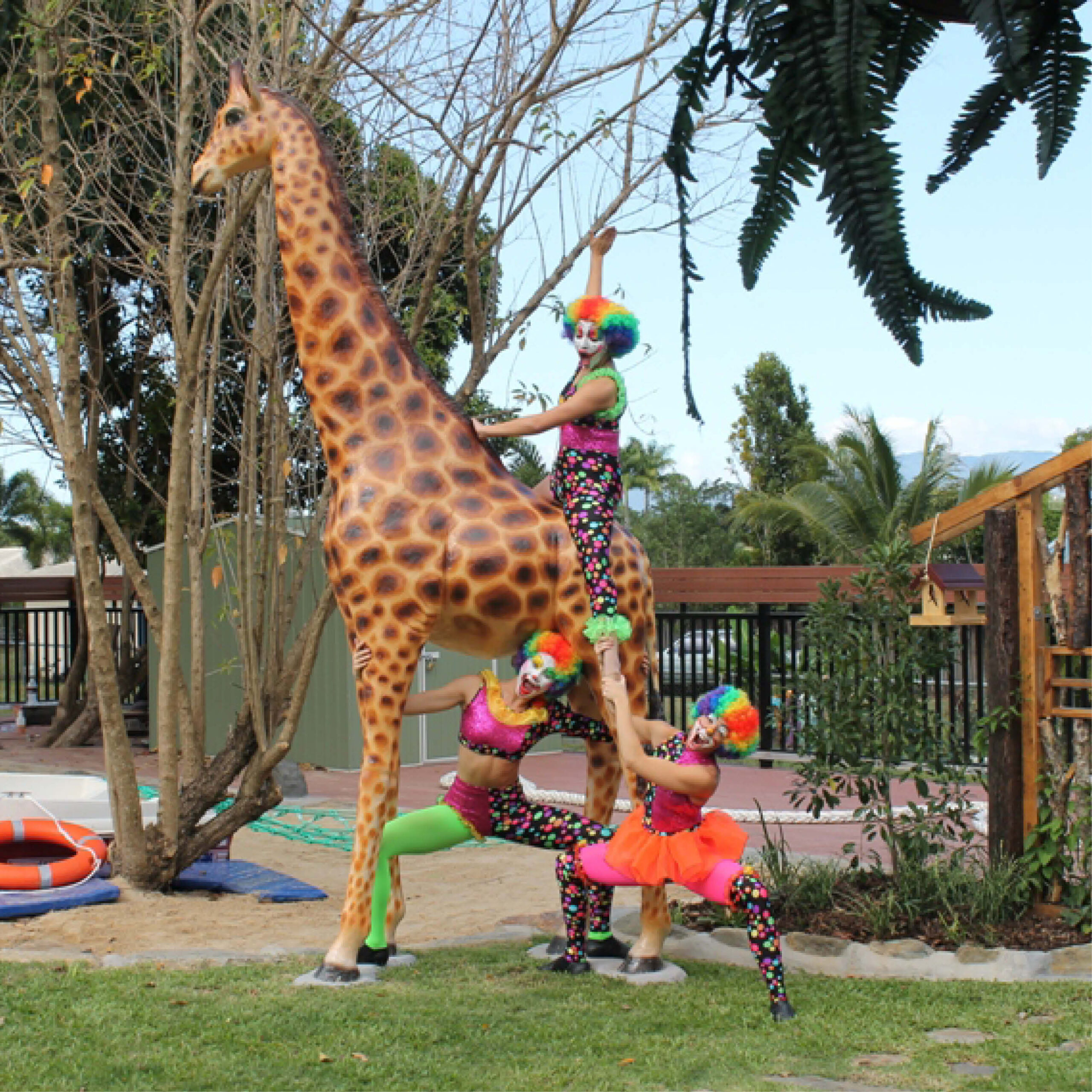 Natureworks Australia Giraffe-18ft-side view-shown displayed in playground at a childcare centre with clowns-140039