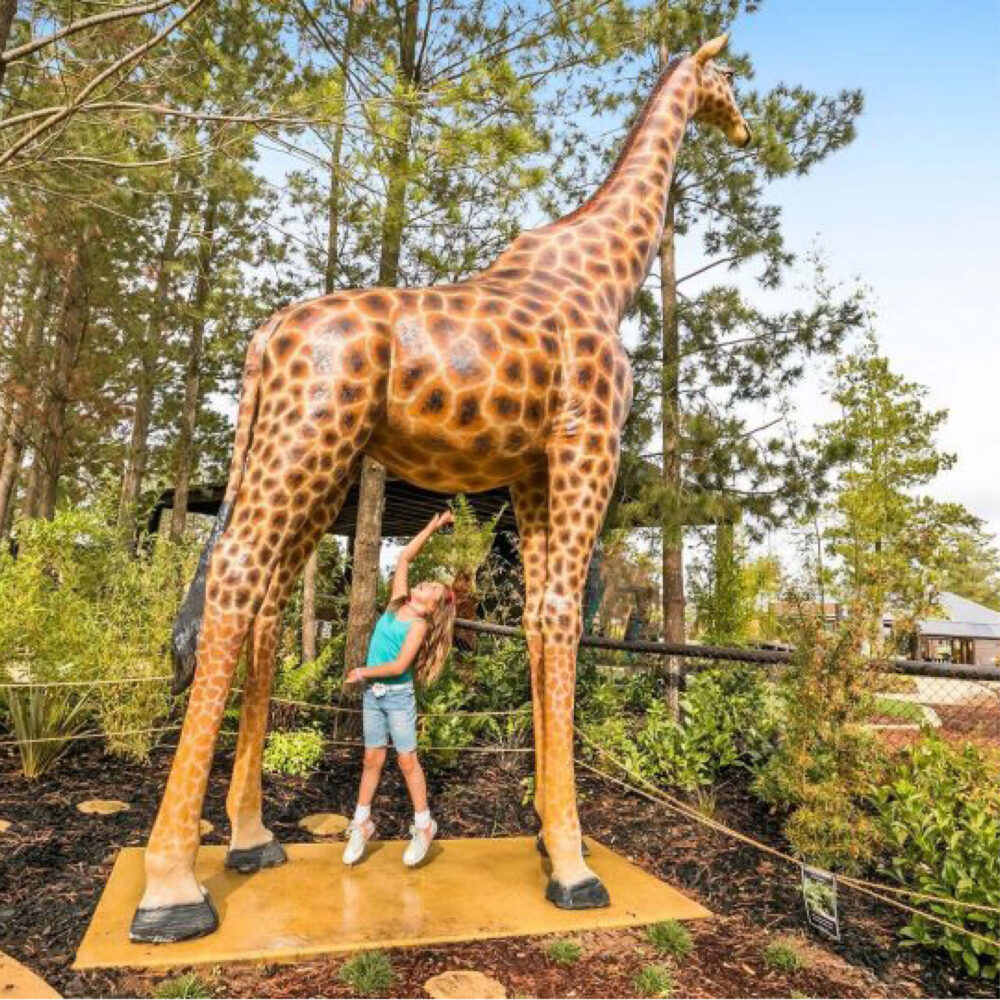 Giraffe-18ft-side view-shown displayed in playground with child underneath-140039