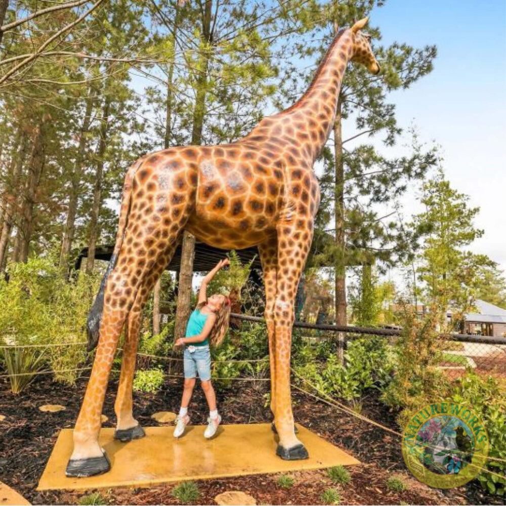 Giraffe-18ft-side view-shown displayed in playground with child underneath-140039