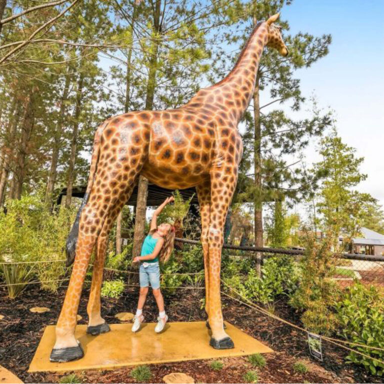 Giraffe-18ft-side view-shown displayed in playground with child underneath-140039