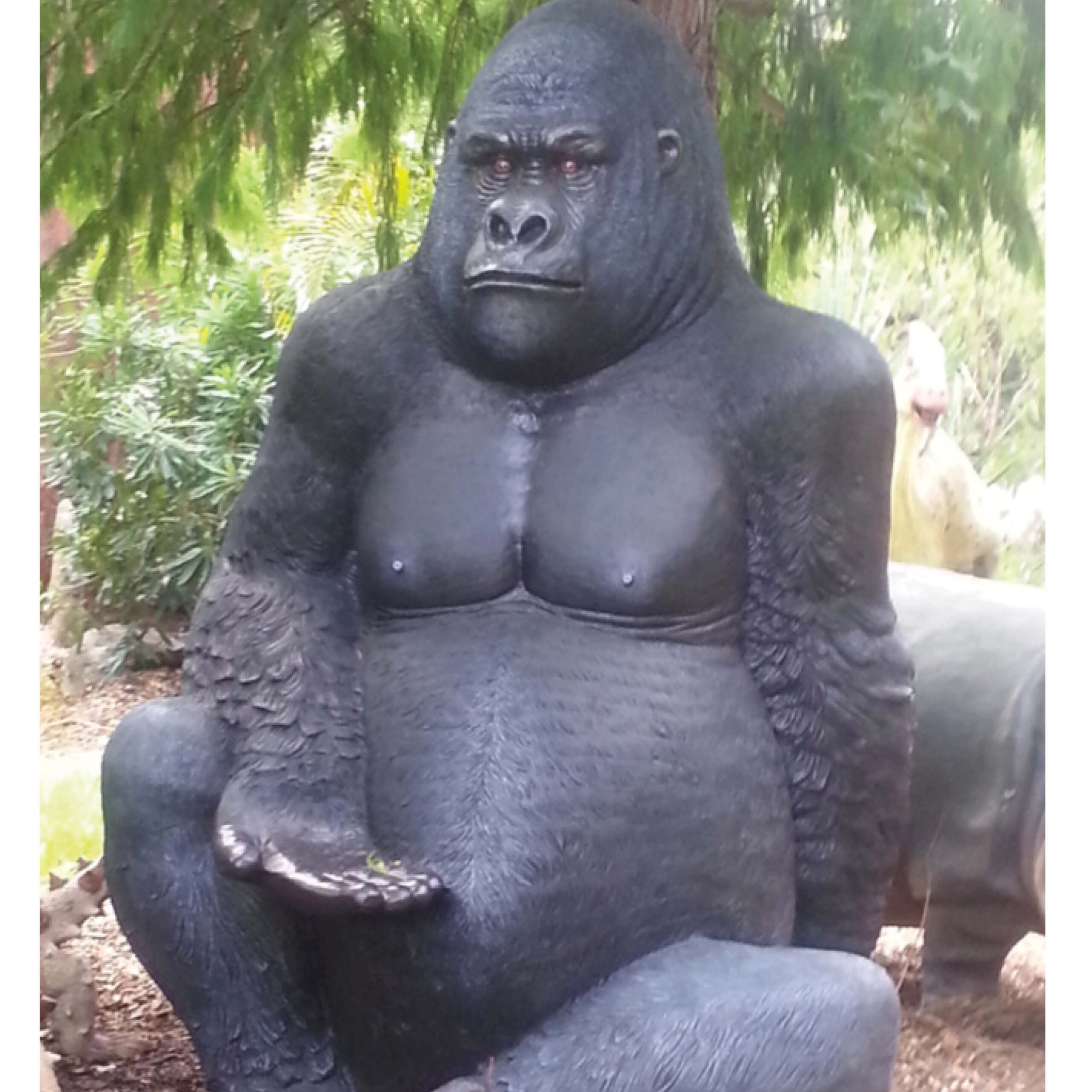 Natureworks Australia Giant Gorilla - Silverback in sitting posse - 8ft high black statue - 110088 - shown outside under trees