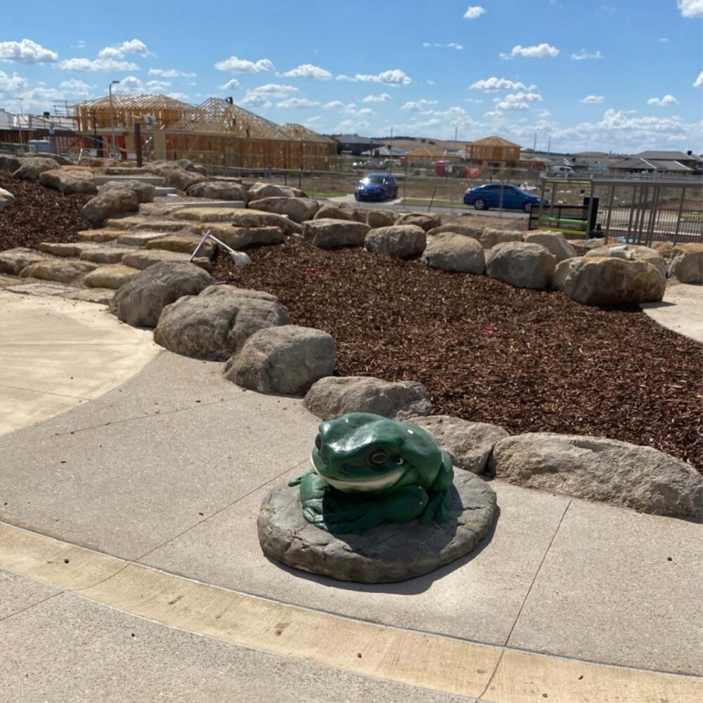 Green Tree Frog on Rock – Giant – 190012Rock - shown outside in public park during installation - Heavy Dutry Verssion