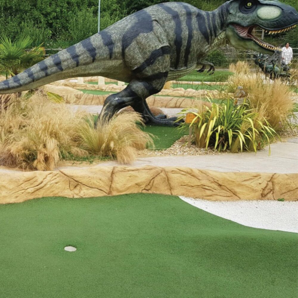 Tyrannosaurus Rex Dinosaur Walking - Shown- in mini-golf course