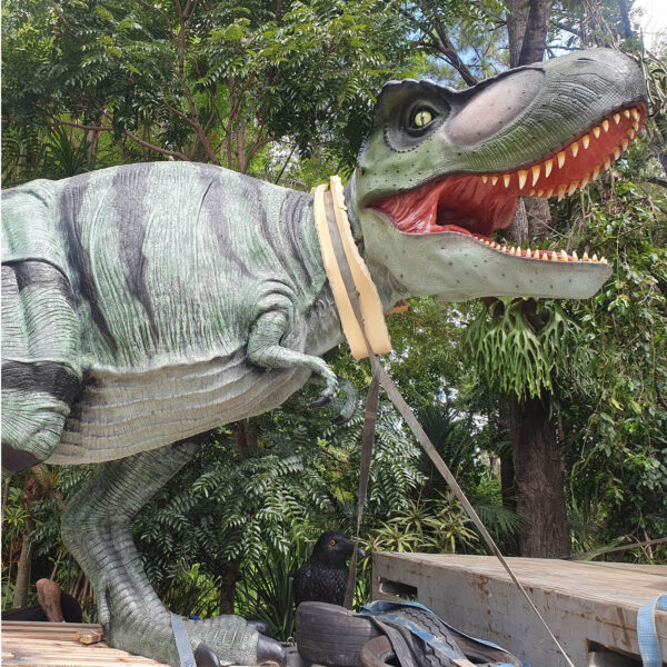 Tyrannosaurus Rex - natural painted finish - walking pose- ready for delivery to customer - close up shown on the back of a truck trailer