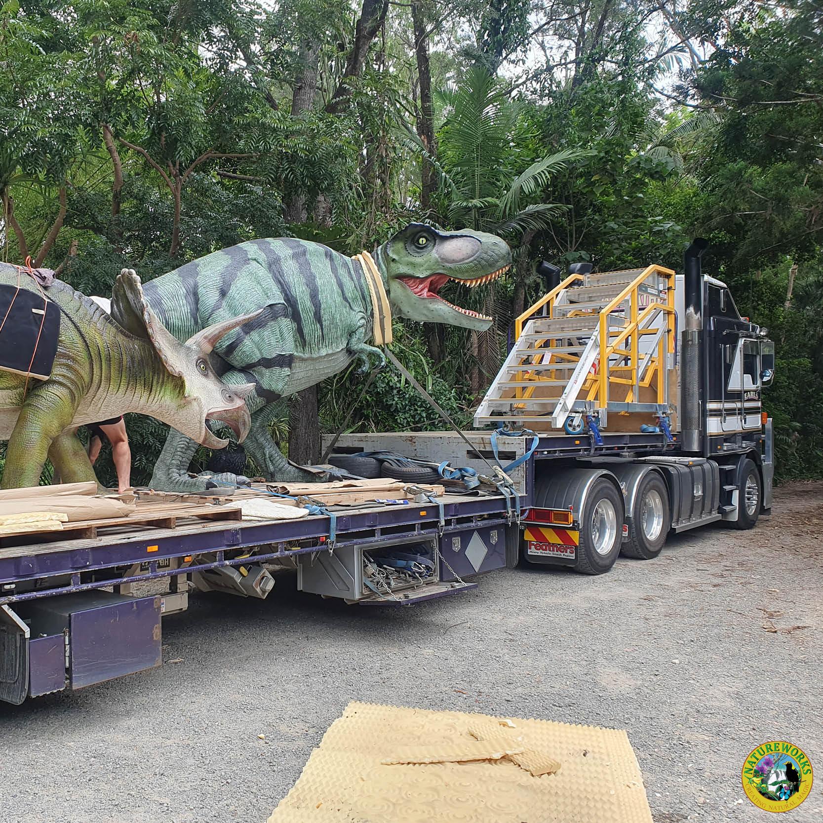 Natureworks Australia Tyrannosaurus Rex - natural painted finish - walking pose- ready for delivery to customer- shown on the back of a large truck trailer with our medium triceratops dinosaur