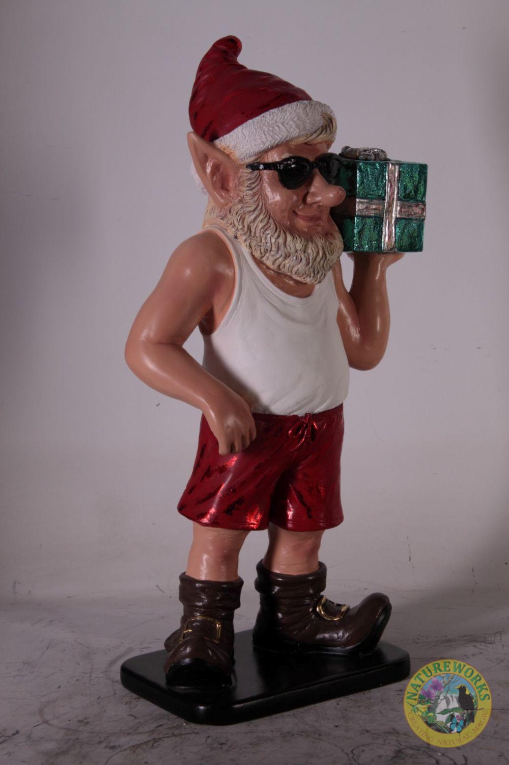 Natureworks Australia Angled view of Christmas elf statue holding a wrapped gift on shoulder.