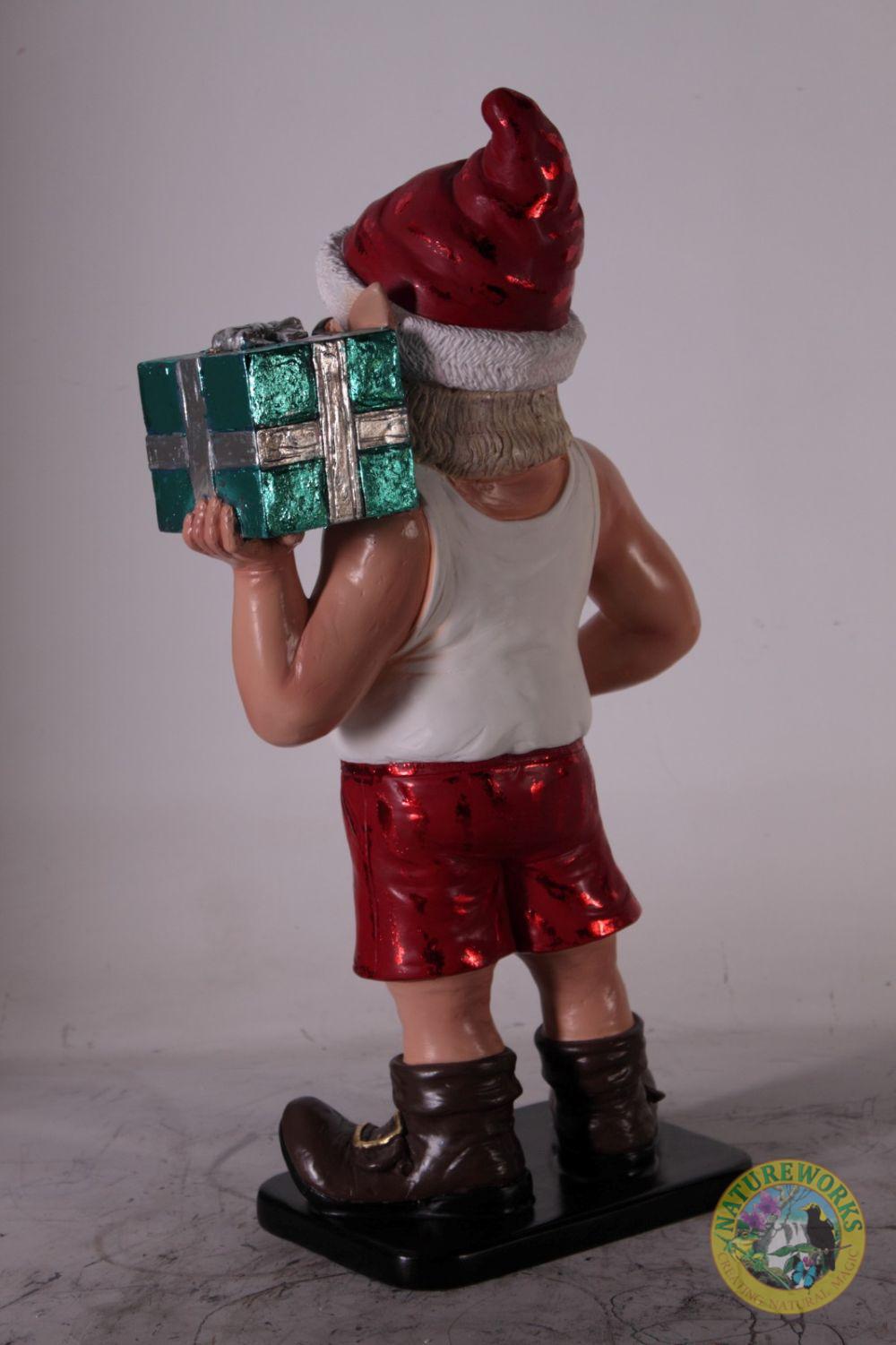 Natureworks Australia Back angled view of Christmas elf statue carrying a present on shoulder.