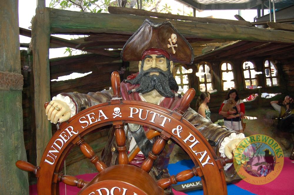 Natureworks Australia sculpture of Pirate at ships wheel in Undersea Putt n Play pirate mini golf