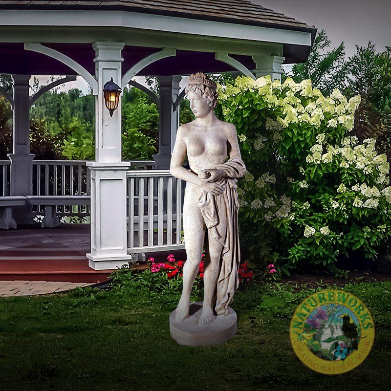 Natureworks Australia Venus holding apple - statue - 090041Rs - Roman stone - shown in garden setting