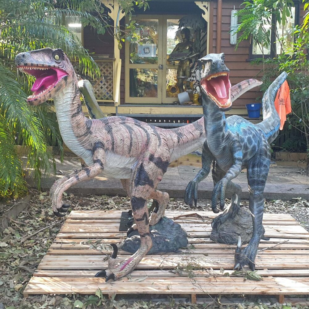 Velociraptor Dinosaur sculpture - Showing blue and natural version together