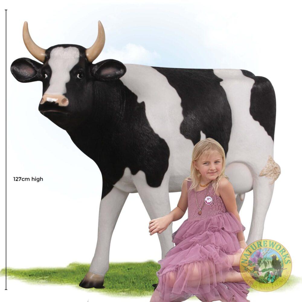 Cow Standing - Friesian 114cm with girl sitting in pink dress