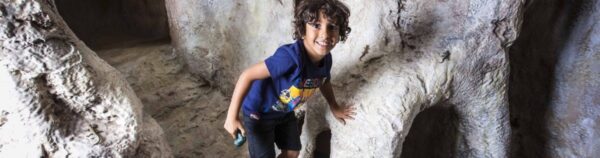 Child playing in cave