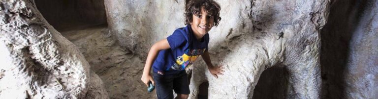 Child playing in cave