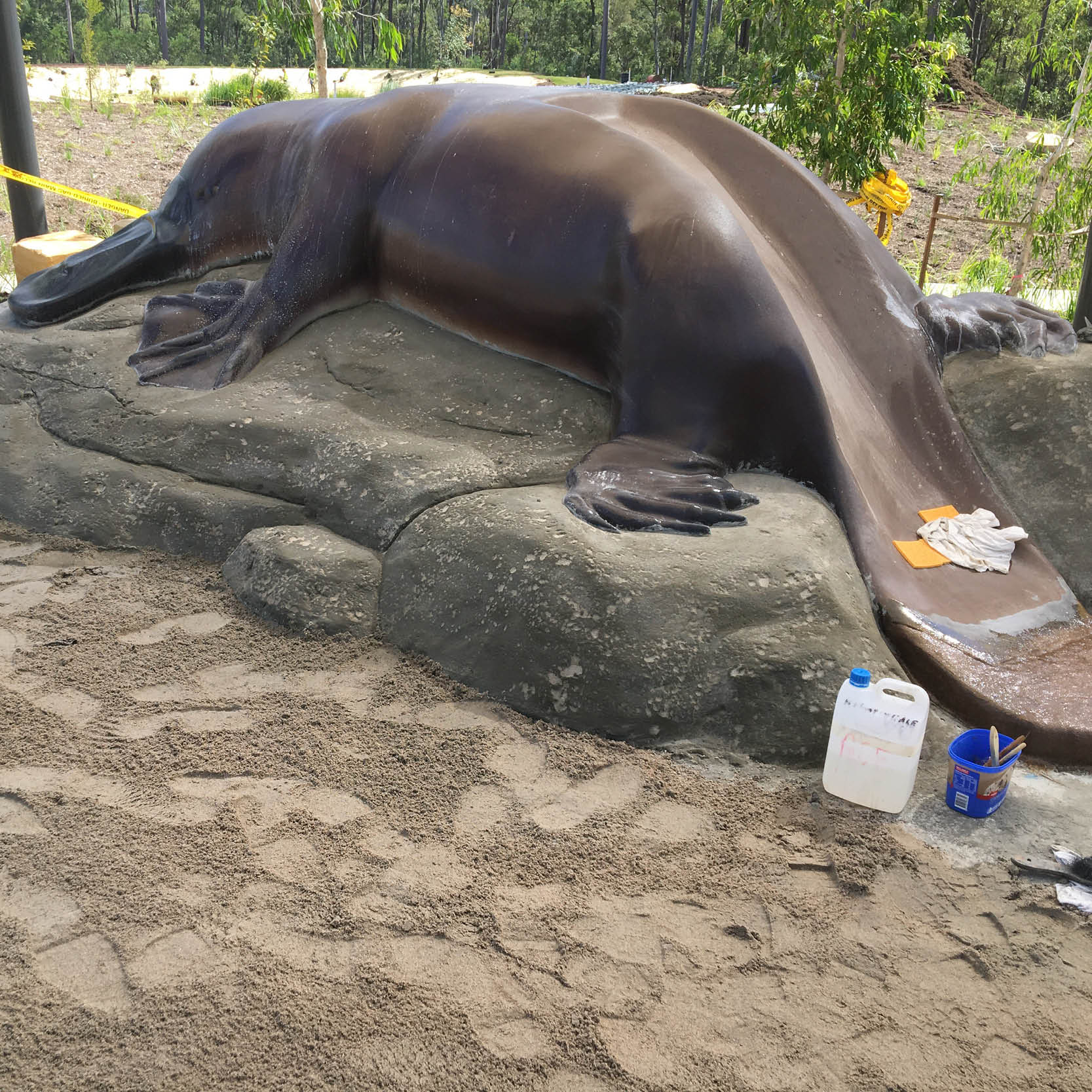 Natureworks Australia Platypus Slide installed in a playground custom sculpt with artificial rock base constructed onsite by Natureworks team. - during installation