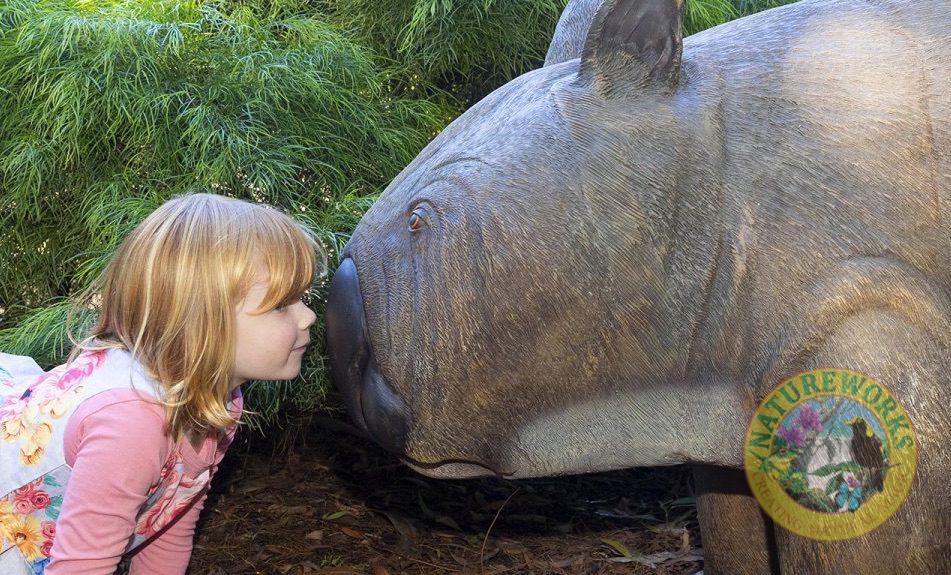 Young girl with phascolonus megafauna sculpture