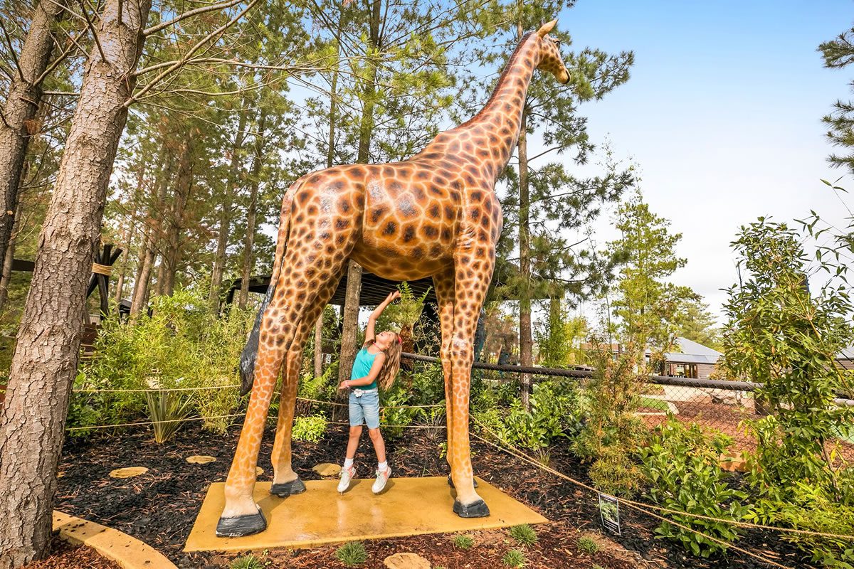 Natureworks Australia Girl under giraffe sculpture