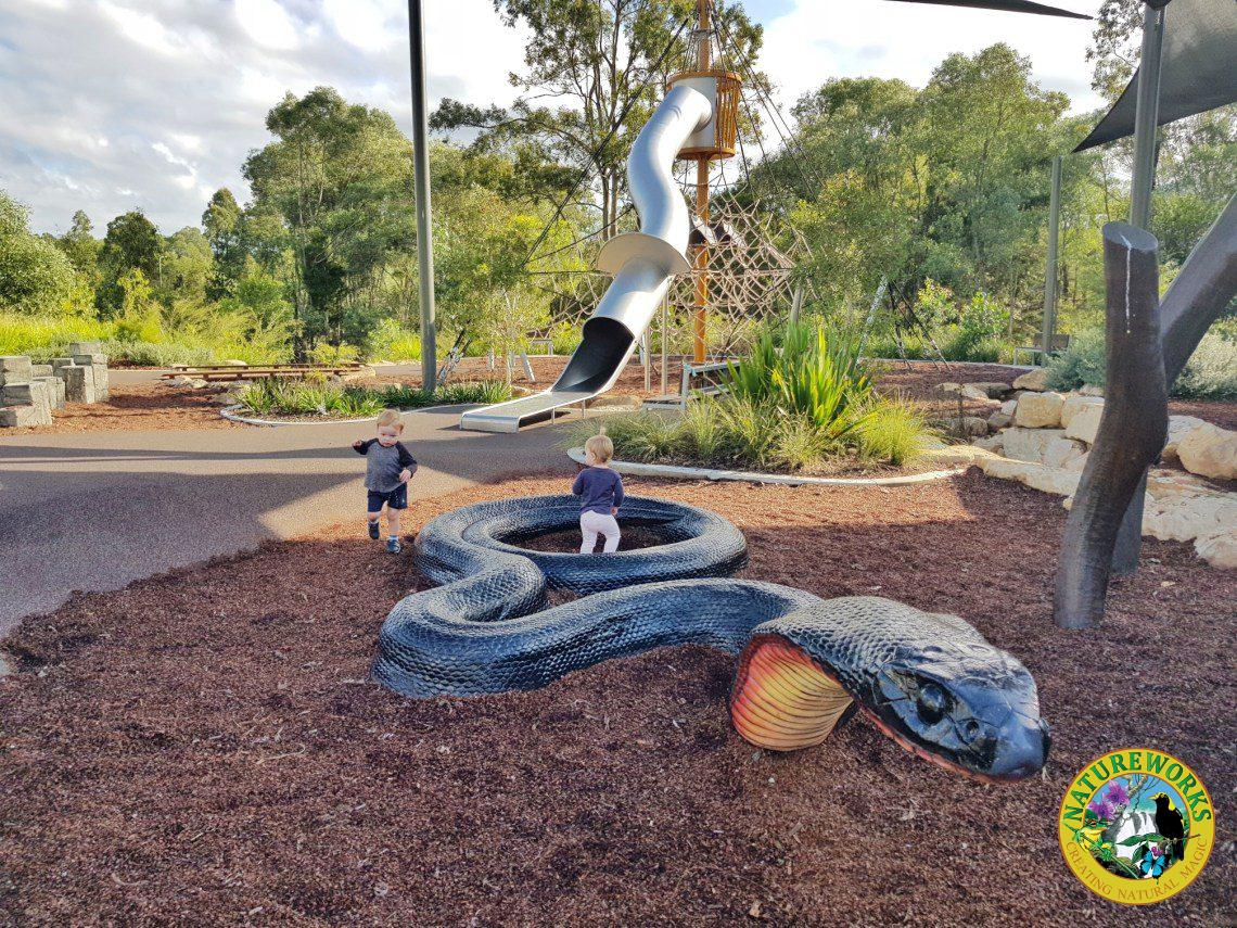 Natureworks Australia Children playing in giant black snake sculpture