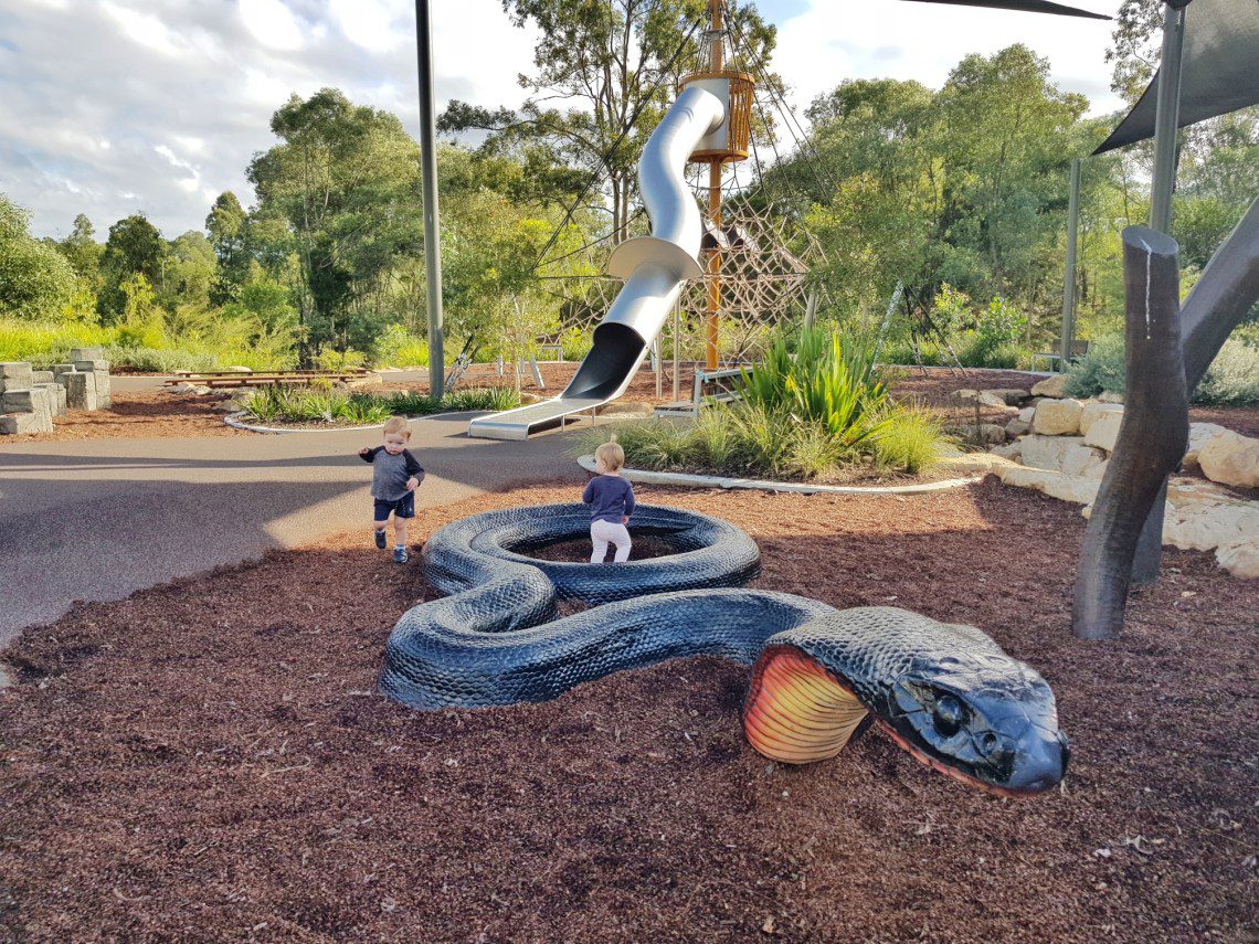 Natureworks Australia Children playing in giant black snake sculpture