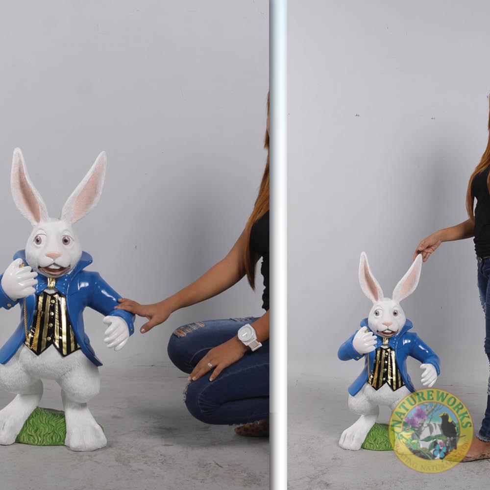 Natureworks Australia Alice in Wonderland White Rabbit Statue with blue jacket and pocket watch. shown front view with Lady
