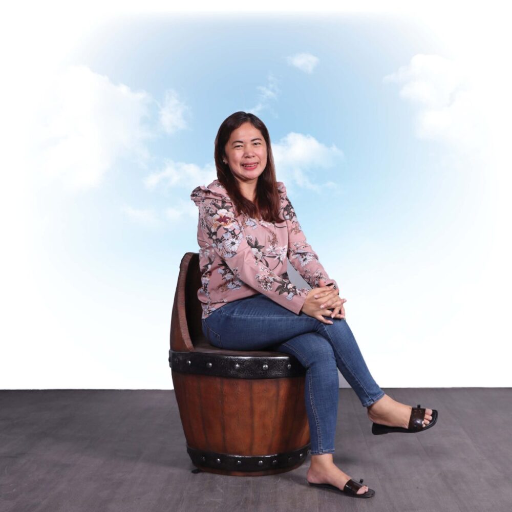 Matching Barrel Chair, -230075 an ideal companion to the Round Timber Faux Barrel Table - shown with lady sitting on barrel chair