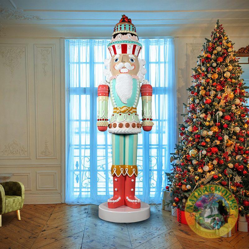 Natureworks Australia Nutcracker Candy Cake - 9ft - 230083- shown in room with christmas tree