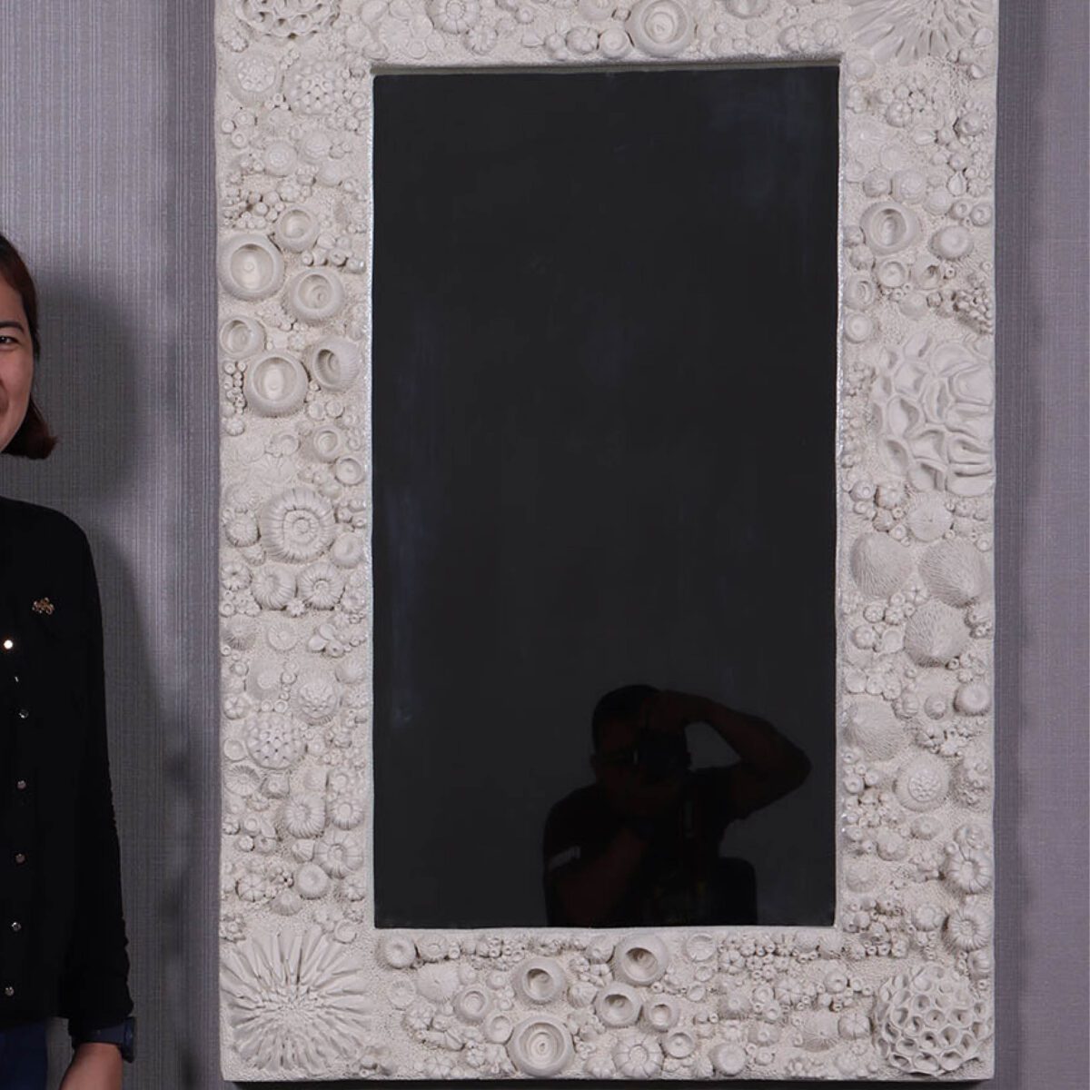 Natureworks Australia Reef Mirror - Medium - SKU 210172 - Roman Stone finish - shown lengthways with lady