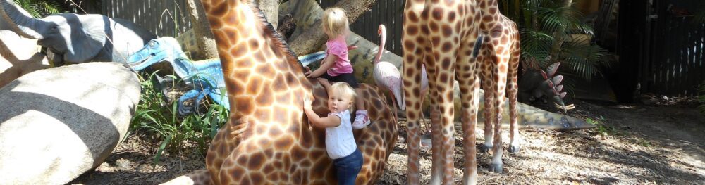 Children playing with animal sculptures