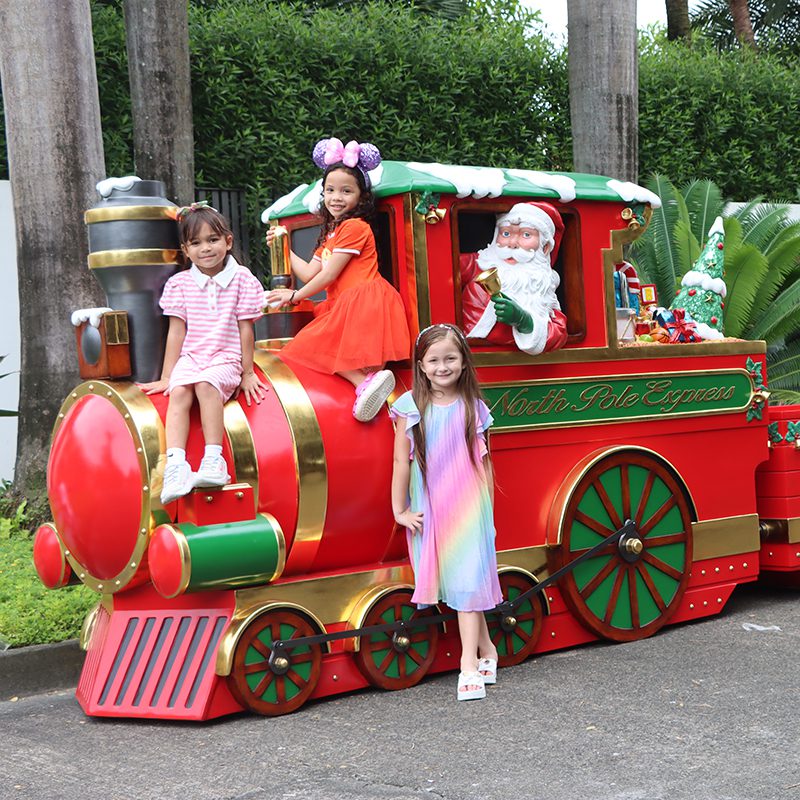 Natureworks Australia Christmas Train - "North Pole Express - 230090 - Shown outside with Santa and Children - V1