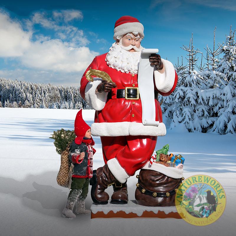 Giant 9ft Santa Statue Standing holding wish list and feathers gold quill. with a sack of toys at the base