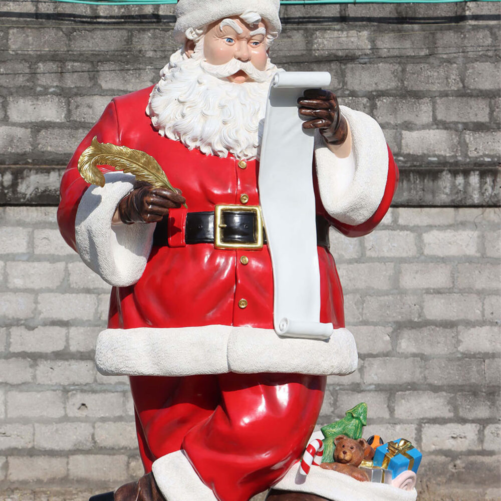 Sanat with Wish list - 9ft high standing tall with his quill ready to add to his list of gifts - sculpture is on a rectangular base plate with a sack of toys at his feet. Size is L149cm x W 119cm x H 285cm - 139kg - SKU 240001 - front view