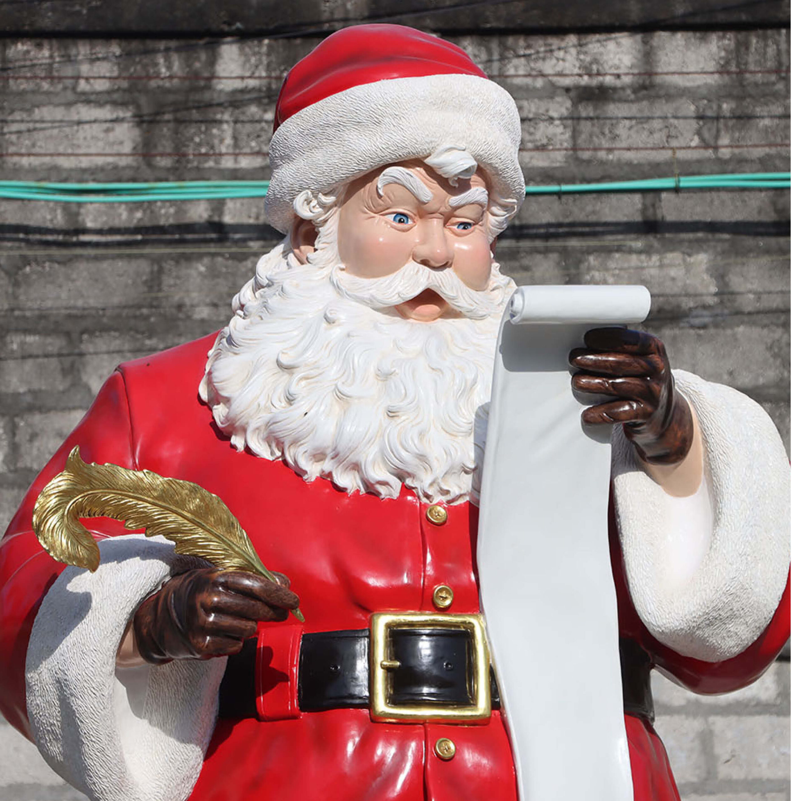 Natureworks Australia Sanat with Wish list - 9ft high standing tall with his quill ready to add to his list of gifts - sculpture is on a rectangular base plate with a sack of toys at his feet. Size is L149cm x W 119cm x H 285cm - 139kg - SKU 240001- close up of head