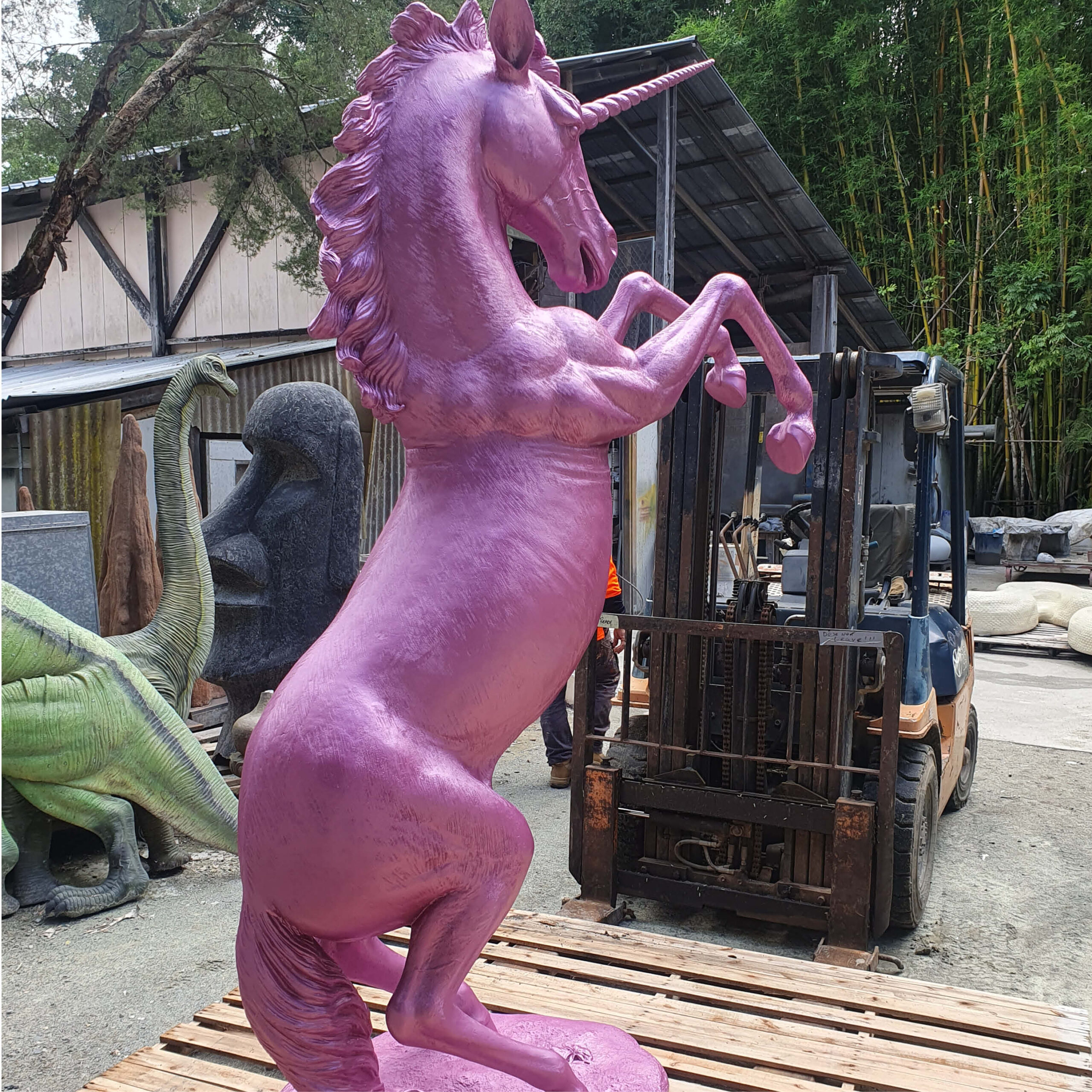 Natureworks Australia Unicorn Rearing statue - full lifesize horse - painted in a Metallic pink. NW.140059UPink - Showing rear angle view with forklift in background