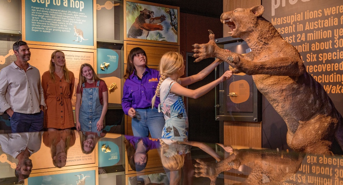 Natureworks Australia Visitors at Riversleigh Fossil Centre beside leaping Thylacoleo sculpture.