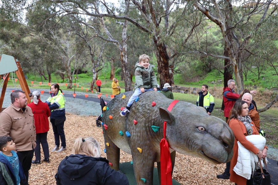 Natureworks Australia Child plays on the Diprotodon statue at the megafauna themed playground on Cormorant Drive in Hallet Cove