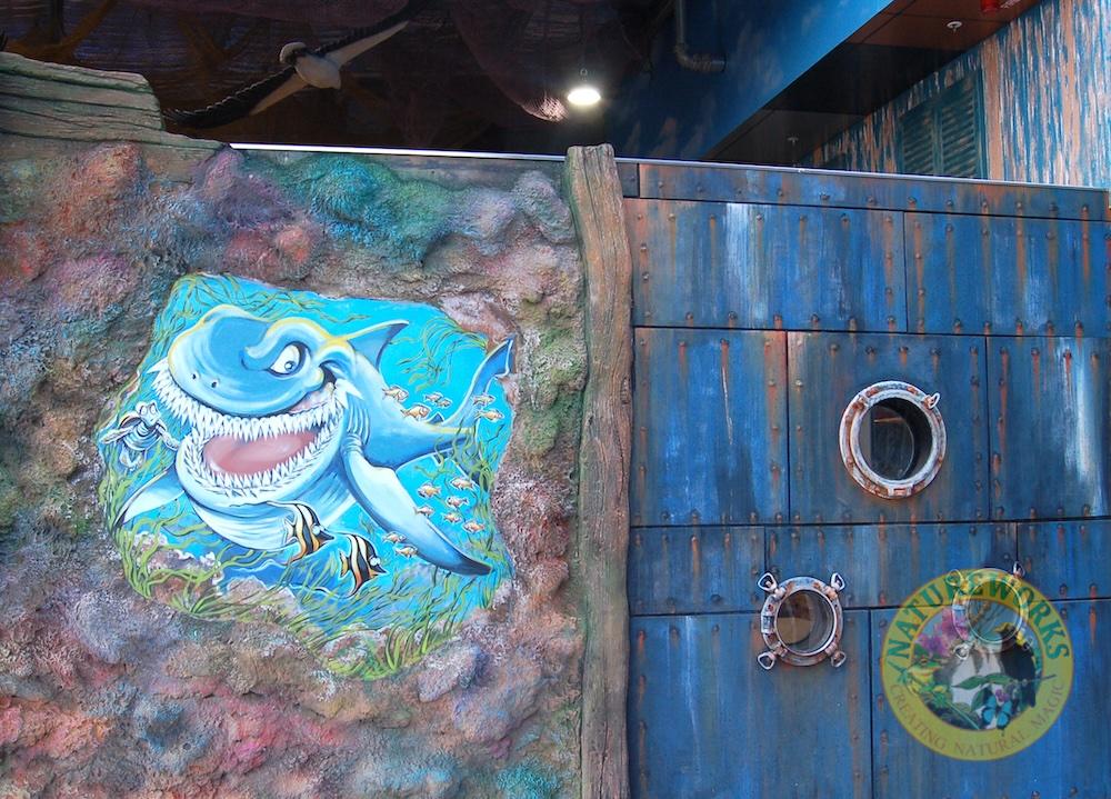 Natureworks Australia Undersea putt & play facade with shark mural and porthole windows