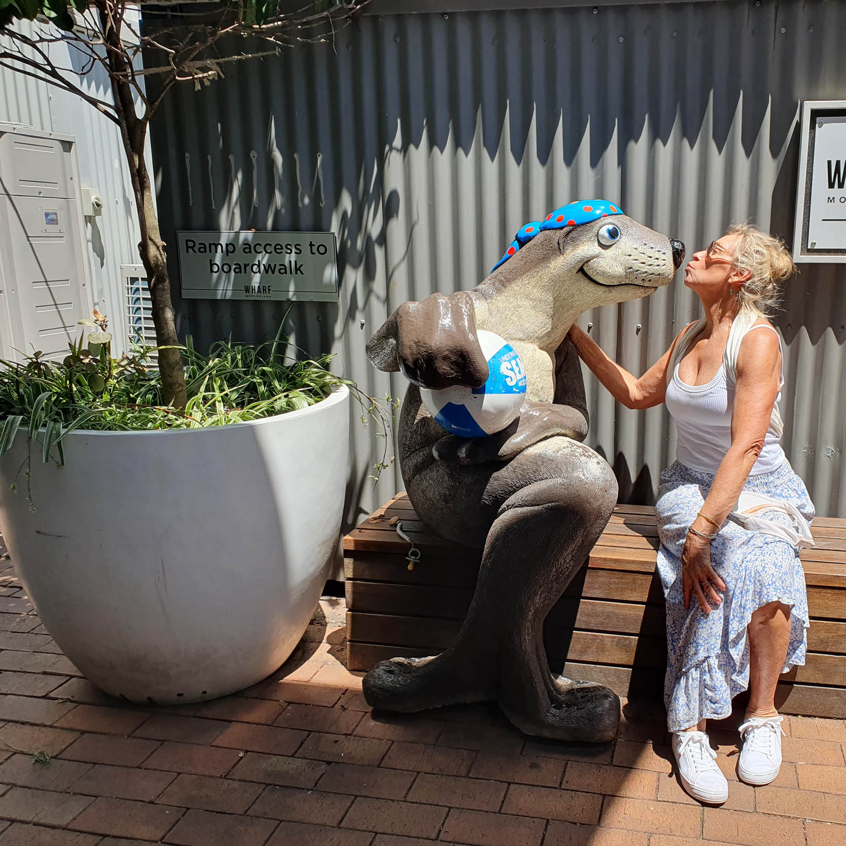 Natureworks Australia Sitting Seal - Sea Life centre Moolooaba- Custom sculpture - showing lady kissing seal