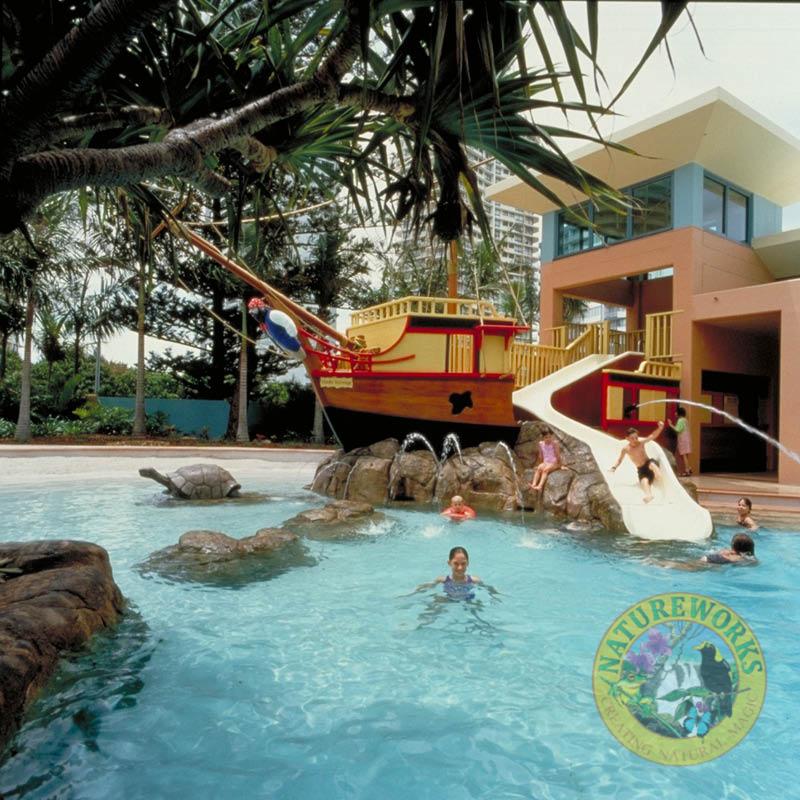 Crown Towers resort - Gold Coast - Artificial rock swimming pool with small rock island and slide with loggerhead turtle