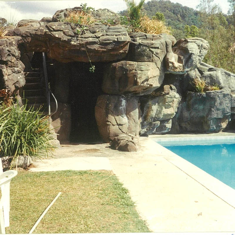 Natureworks Australia Artificial rock cave with slide - custom designed, manufactured and installed by Natureworks to enhance the community area of the golf course.- close up of cave ans stairs