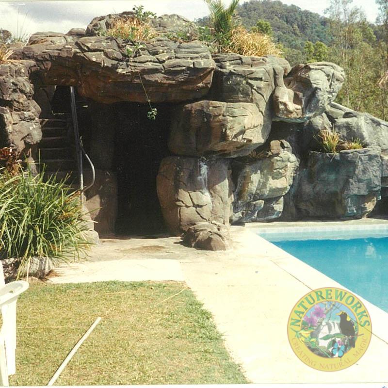 Natureworks Australia Artificial rock cave with slide - custom designed, manufactured and installed by Natureworks to enhance the community area of the golf course.- close up of cave ans stairs