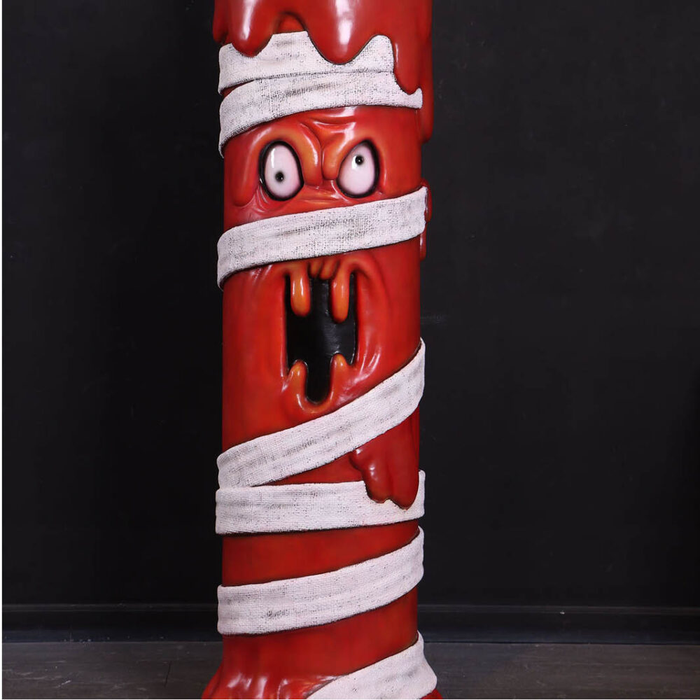 Mummy Candle Sculpture — red wax candle wrapped in bandages with flame, life-size Halloween prop
