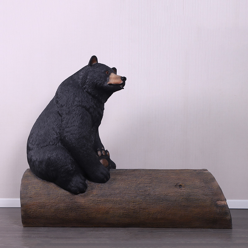 Natureworks Australia Bear sitting on tree trunk - bench seat - looking right