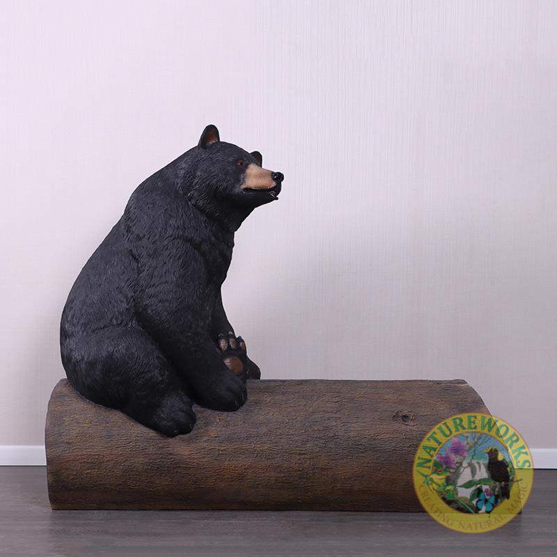 Natureworks Australia Bear sitting on tree trunk - bench seat - looking right
